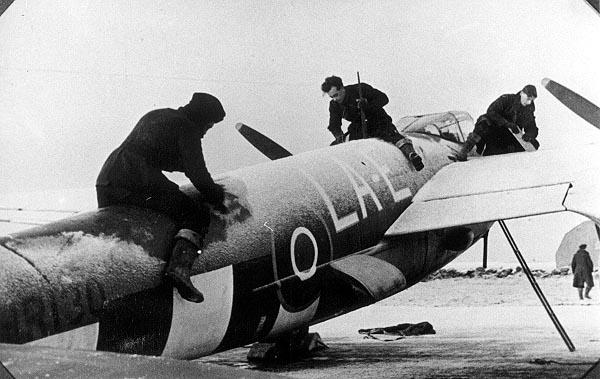 Scraping the snow and ice of a Maosquito at RAF Banff